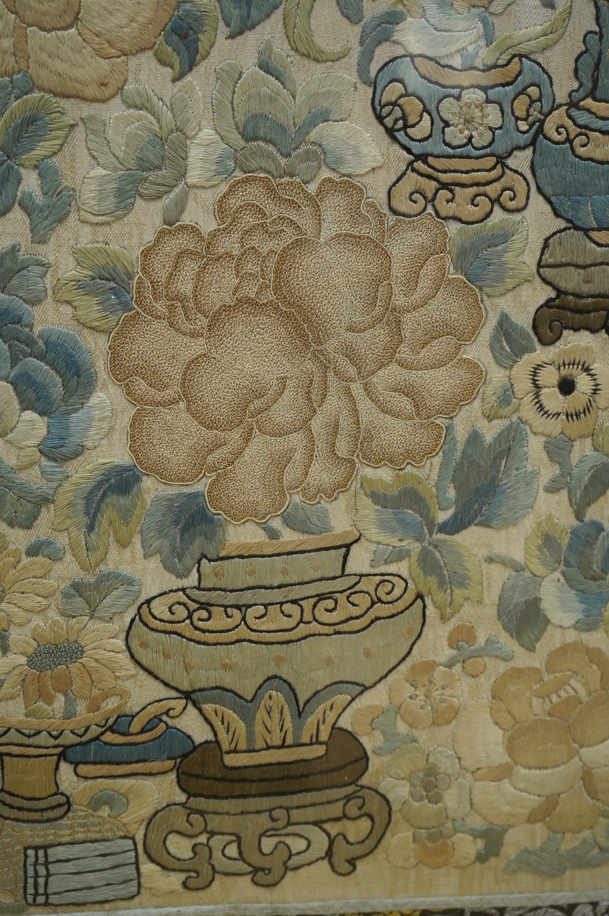 Two 19th century Chinese silk embroideries, one of a Chinese a musician on horseback and a boy behind carrying a banner, the other a Chinese knot floral embroidery of vases of flowers with brocade border, both embroideri